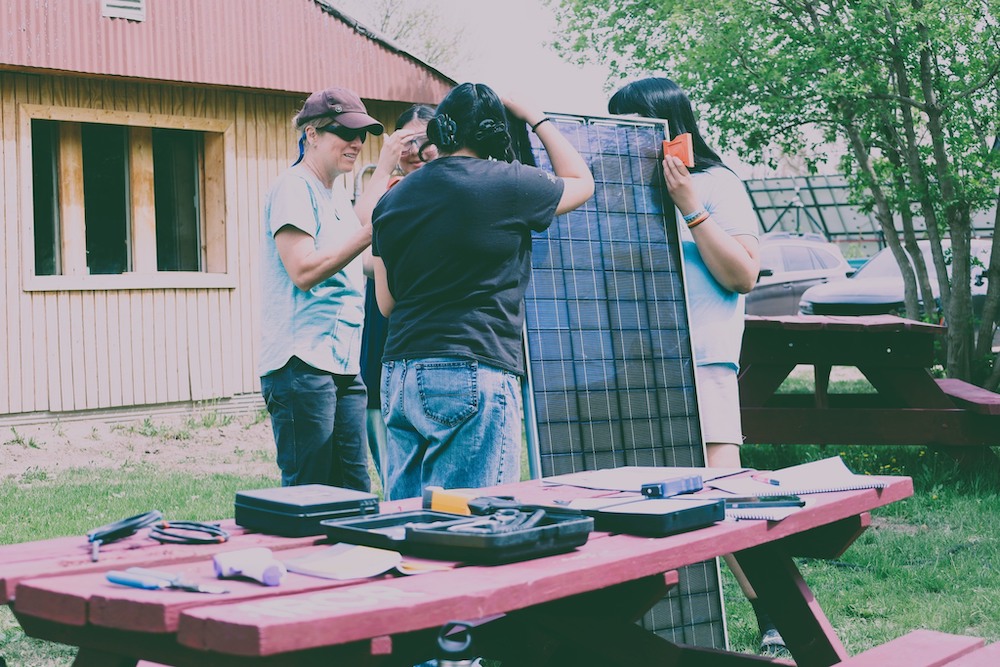 Instructor Laura Walters explains a solar panel to students in Red Cloud Renewables’ solar installation training program. (Courtesy Photo)