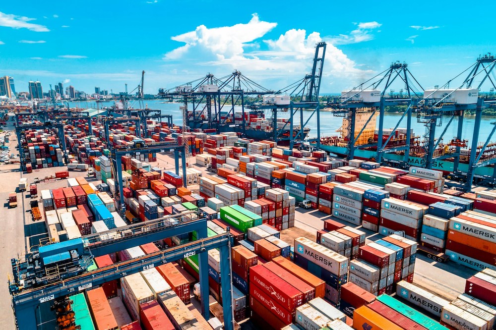 Shipping containers crowd a busy port terminal where international trade faces disruption under Trump's sweeping tariffs. For tribal enterprises from Suquamish geoduck harvesters to Pokagon Band contractors, these supply chain pressures have prompted innovative strategies—from pre-purchasing Canadian components to exploring Jay Treaty protections. (Photo: <a href="https://unsplash.com/@mkumbwajr" alt="Ali Mkumbwa" target="_blank">Ali Mkumbwa</a> via <a href="https://unsplash.com" alt="Unsplash" target="_blank">Unsplash</a>)
