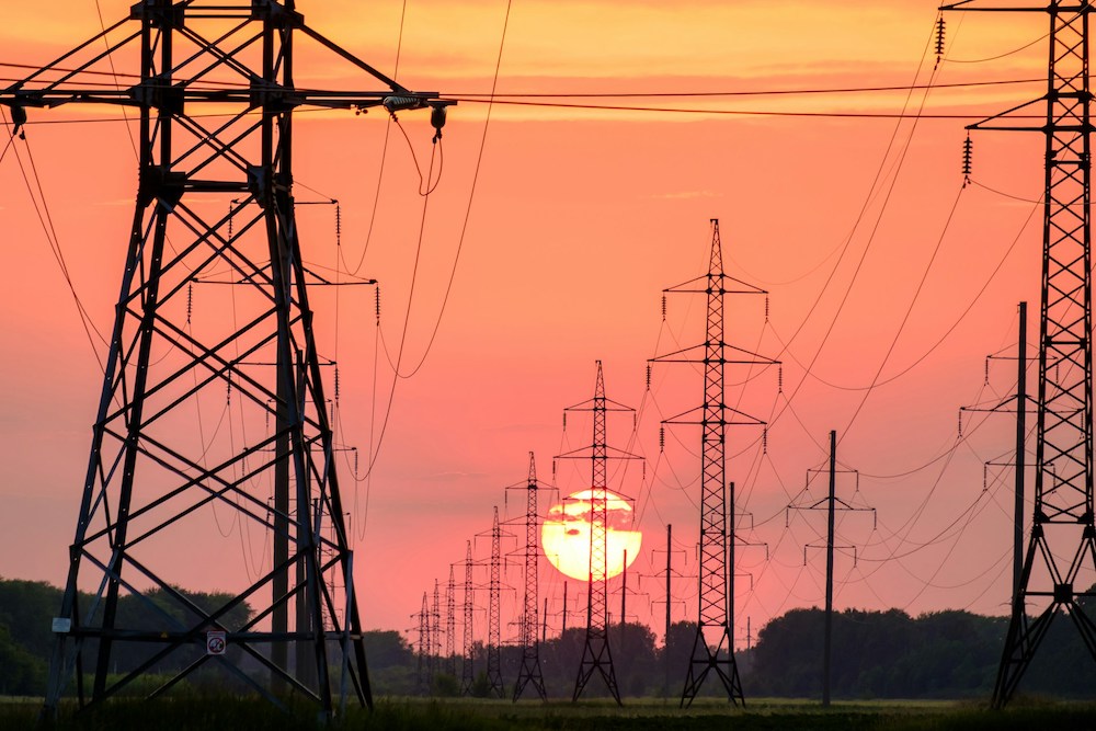 A new tribally owned entity is helping tribes cut their energy costs and forge a path toward energy independence and economic sovereignty. (Photo: <a href="https://unsplash.com/photos/silhouette-of-electric-post-during-sunset-qpAOxji4dAo" alt="Andrey Metelev" target="_blank">Andrey Metelev</a> via UnSplash)